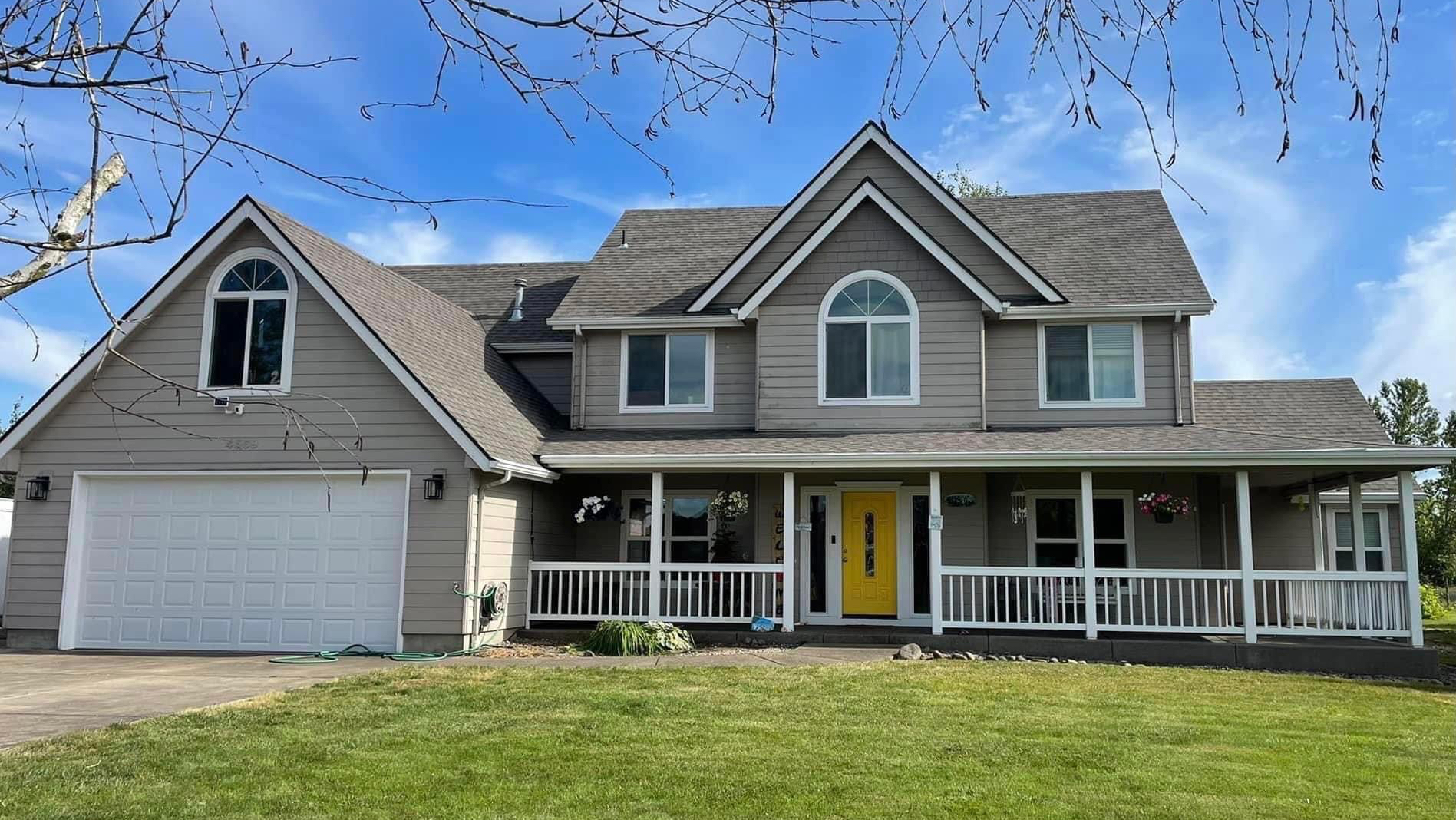 Completed shingle roof replacement on a two-story home in Lebanon, Oregon